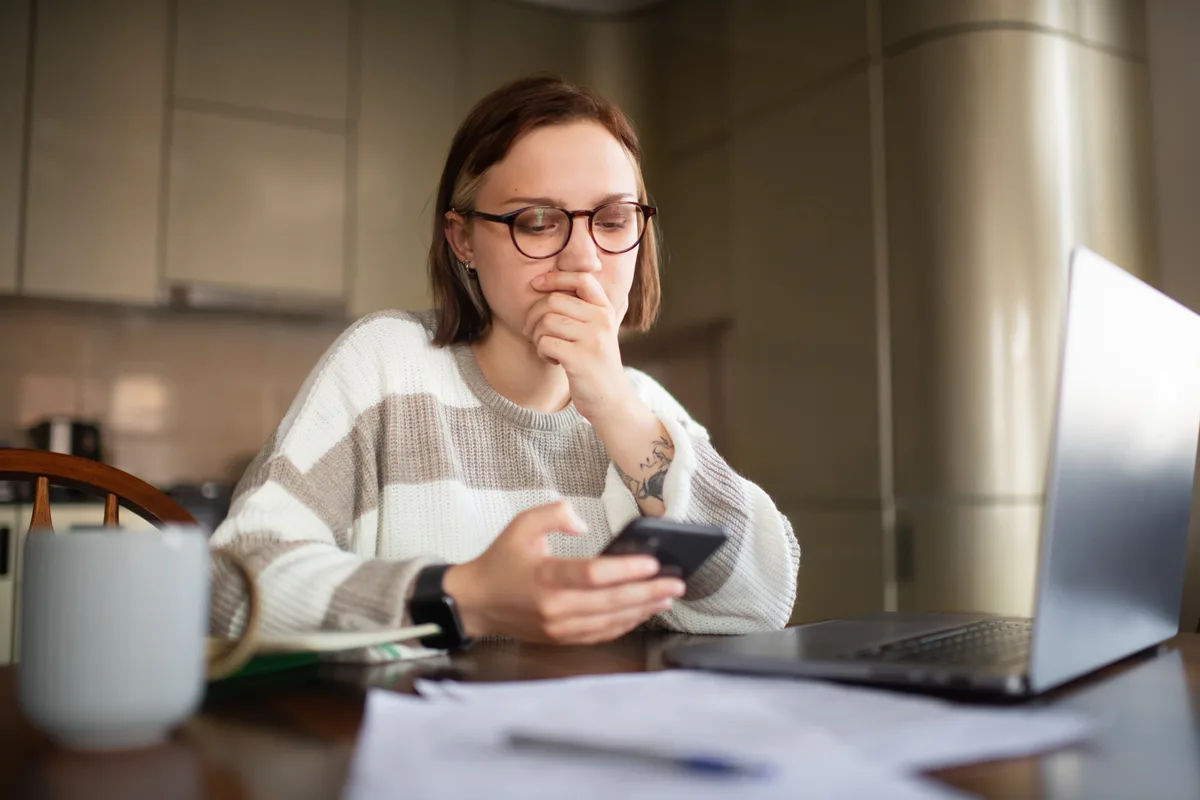 Homeowner on the phone calling for emergency HVAC service in a Toronto-area home