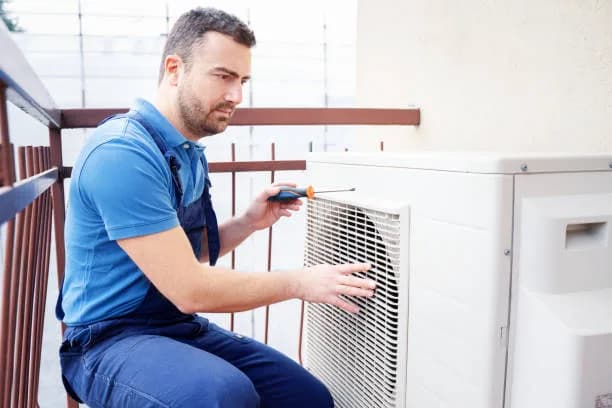 Homeowner preparing outdoor AC unit for summer in Ontario