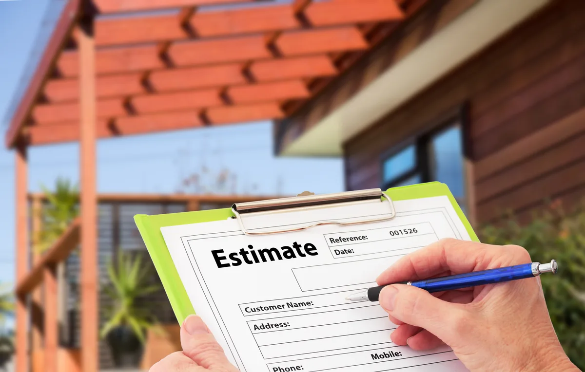 Homeowner reviewing a free written HVAC installation quote at a GTA kitchen table