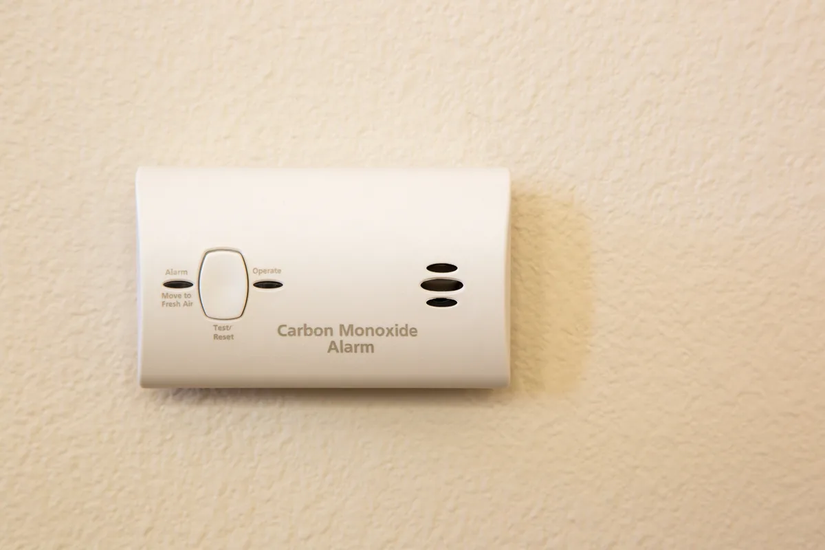 Carbon monoxide alarm mounted on a wall in a home