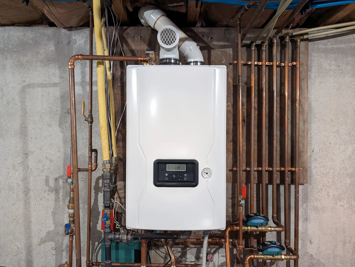 Wall-mounted condensing tankless water heater saving floor space in a GTA home utility room