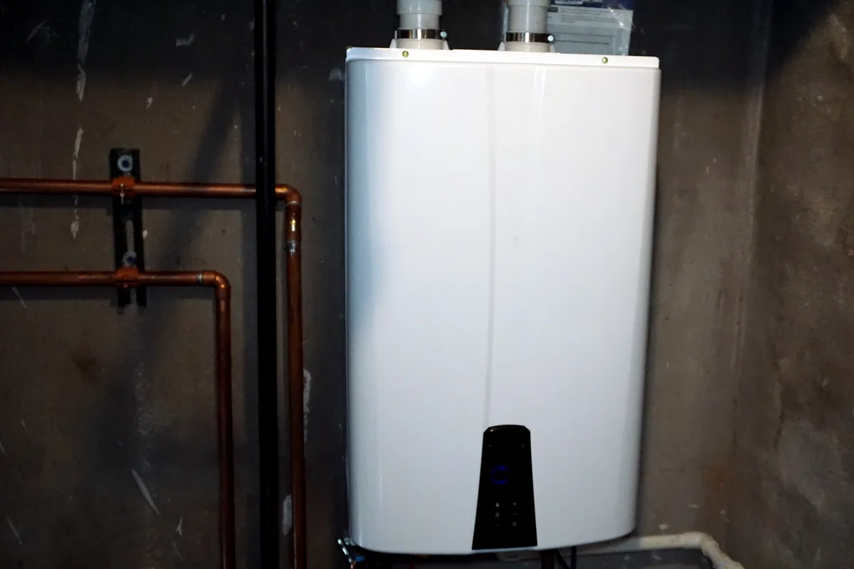 Wall-mounted condensing tankless water heater installed in a GTA home utility room