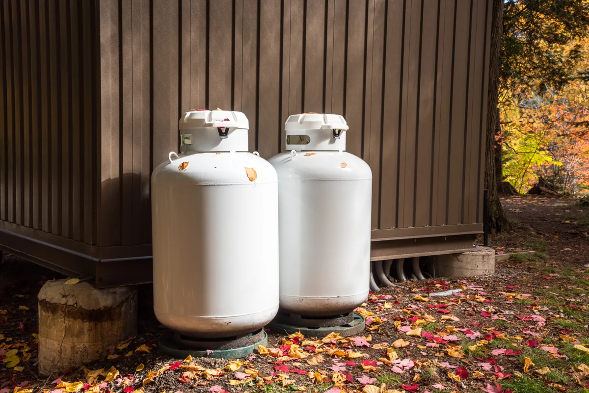 Above-ground propane storage tank beside a rural Ontario house in winter