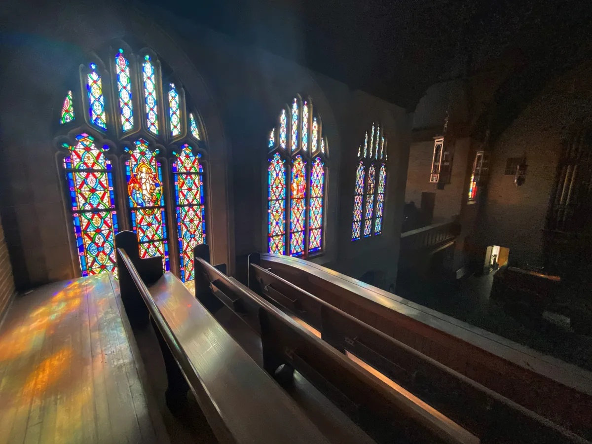 Sunlight pouring through the stained glass windows of a church