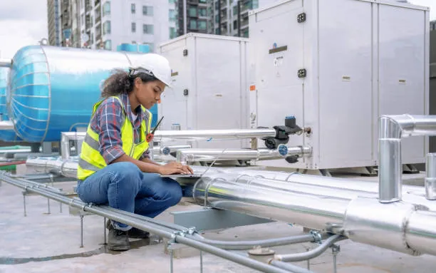 Technicians servicing commercial rooftop HVAC unit