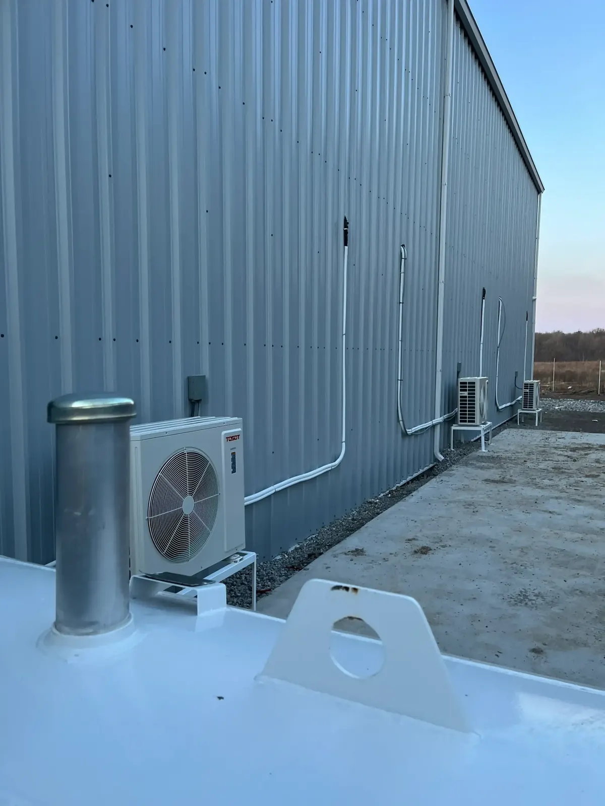Commercial condenser units along industrial building exterior