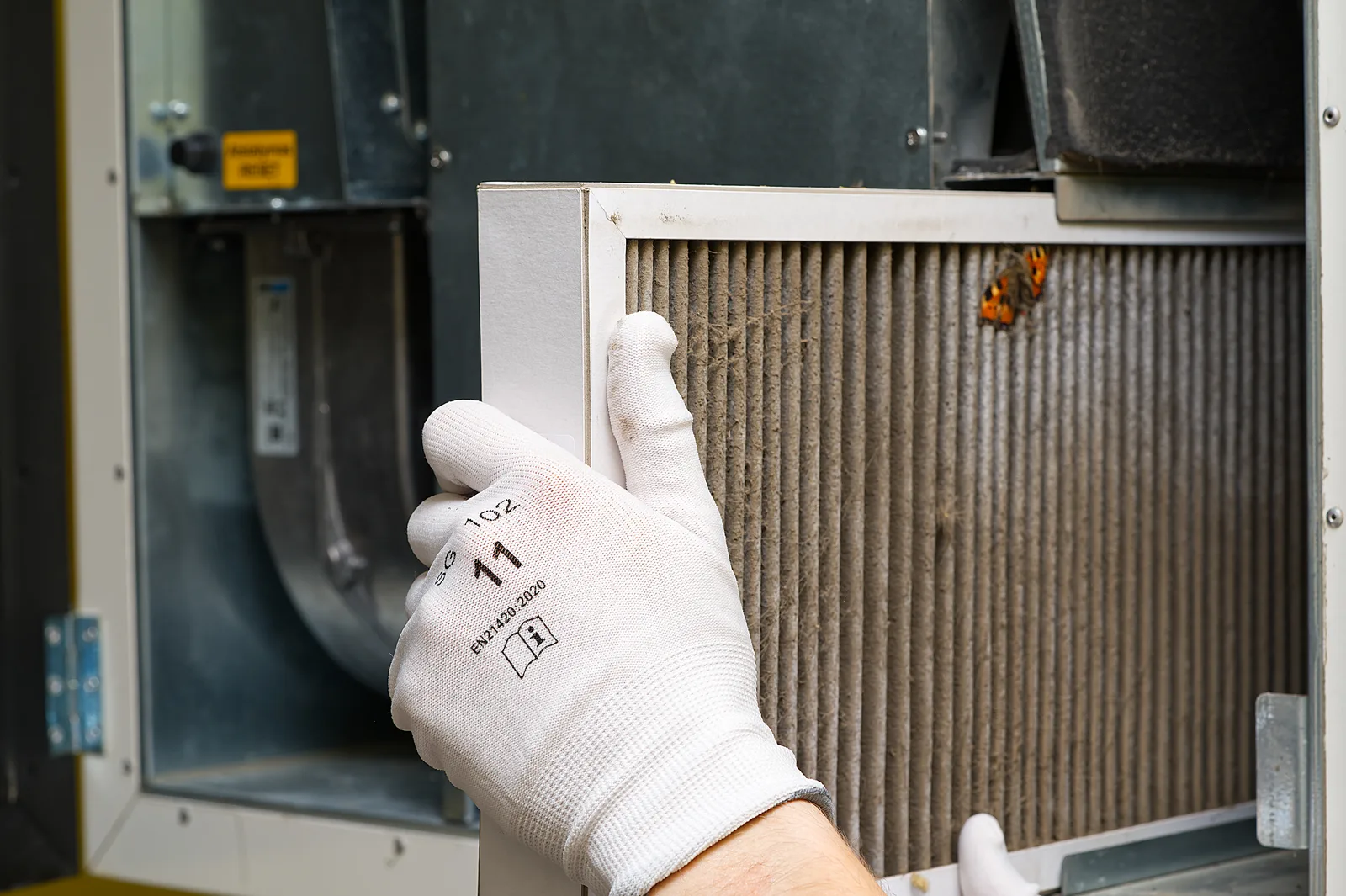Replacing a furnace air filter during a seasonal HVAC tune-up