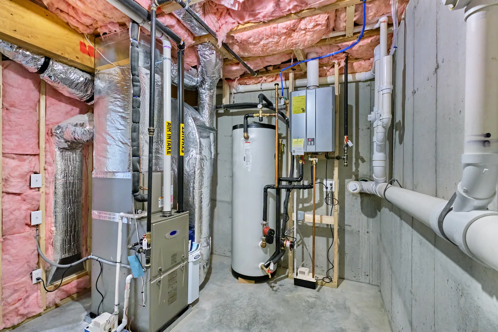 Mechanical room with a tank water heater, gas furnace and tankless unit