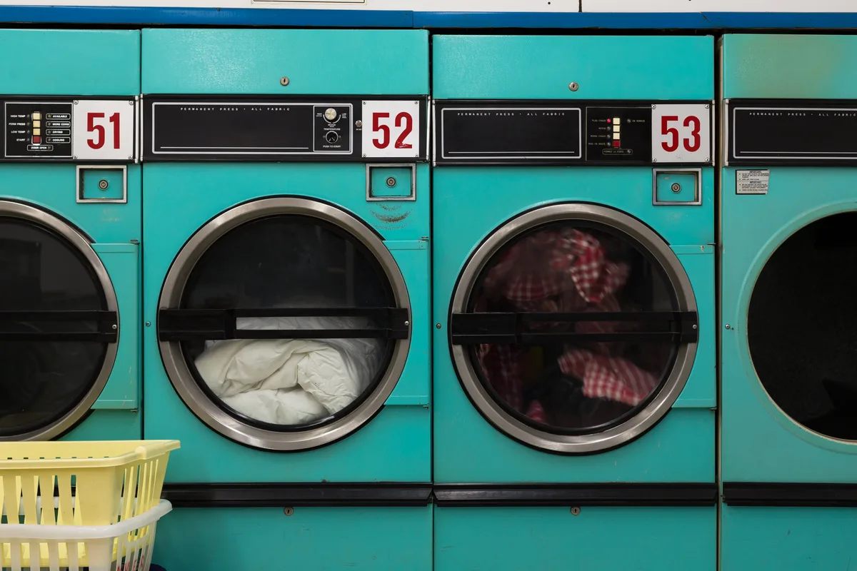 Row of clothes dryers in a laundromat